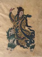 Close view of artwork showing robed figure, lion-dog and hand-coloring details