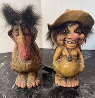 Front view of both Nyform troll figurines