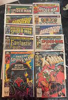 Front view of all ten bagged comics laid out, showing titles and covers