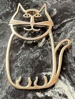 Front view of sterling silver outline cat brooch