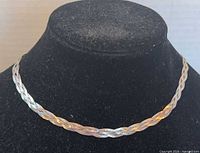 Necklace on display bust showing braided pattern