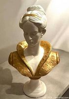 Front three-quarter view of plaster lady bust showing gilded collar detailing