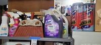 Shelf with spray cleaners, detergent, Lysol jug, vintage dustpan front