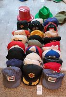 Front view showing rows of baseball caps and two novelty hats
