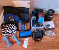 Overall lot showing cases, Sony clock, pill organizers, dumbbells