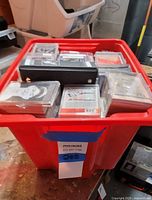 Red bin filled with sleeved trading cards