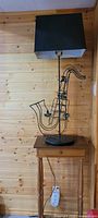 Wood side table with saxophone lamp displayed