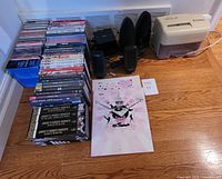 Overview of DVDs, CDs, speakers, shredder and Sony clock