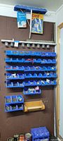 Full view of wall-mounted blue bins, jars, wood holder