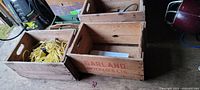 Three Garland Beverages crates, one containing yellow rope, another empty