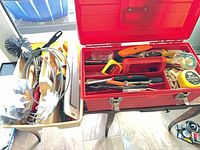 Red toolbox and beige caddy full of assorted tools