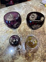 Four crystal glasses showing colors and cut patterns