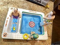 Top view of ceramic pool chip and dip dish with figurines