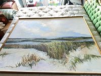 Full view of framed landscape painting on mattress