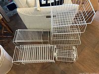 Group view of all wire shelf risers and baskets on floor