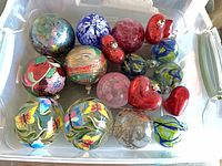 Top view of plastic bin showing majority of hand-painted and blown-glass ornaments
