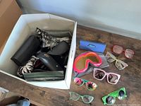 Overview showing box with sunglasses, goggles and cases