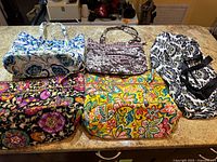 Group shot of five Vera Bradley bags showing all patterns and shapes