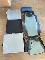 All items laid out: Snailax massage seat cushion with headrest and cords, grey lumbar pillow, black seat cushion, light grey seat cushion, blue bolster pillow