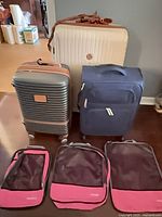 Front view of three suitcases and three packing cubes