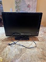 Front view of Philips 22-inch LCD TV/monitor with stand and attached power cord