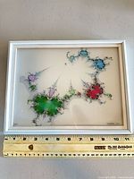 full view of framed Ray Balbes print with ruler for scale