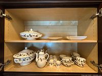 Cabinet view showing both shelves with majority of pieces