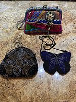 Front view of all three beaded purses