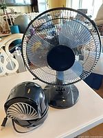 Both fans side by side showing size difference