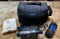 Full bundle showing camcorder, case, manual, power cable
