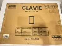 Factory sealed Clavie mirror carton front showing branding and fragility labels