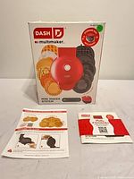 Front view of boxed Dash Multimaker system with manuals