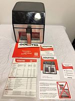 Front view of Gourmia air fryer and included manuals/charts