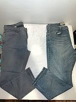 Both pairs of jeans laid flat, full length view