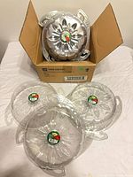 Box containing multiple clear hanging saucers