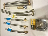 Group shot showing Everbilt kit, four loose connectors and packaged spray hose