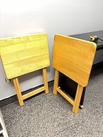 Both folding TV tray tables standing folded