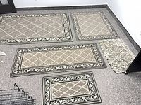 Group of four patterned rugs and shag mat on floor