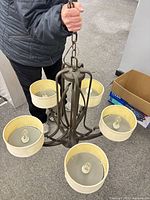 Full view of chandelier held by chain showing five shaded lights