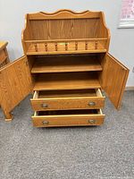 Front view with doors open and drawers partially extended