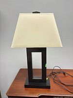 Front view of black metal table lamp with shade