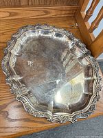 Top view of ornate WA Rogers silver plated platter showing rim design and surface wear