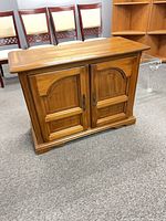 Front view showing paneled doors and hardware