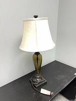 Full view of lamp with shade on tabletop