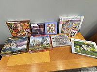 Group shot of all boxed puzzles and Cat Stax on tabletop