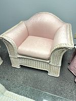 Wicker armchair front view showing cushions and frame