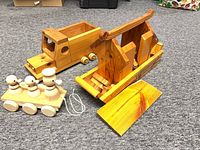 Truck, pull-ducks toy and Noah’s Ark with ramp displayed on carpet