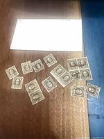 All sixteen Nathan Hale stamps on table