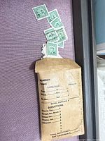 Small envelope with portion of green Canadian stamps showing