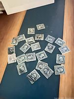 Group of 23 blue Franklin stamps spread on surface